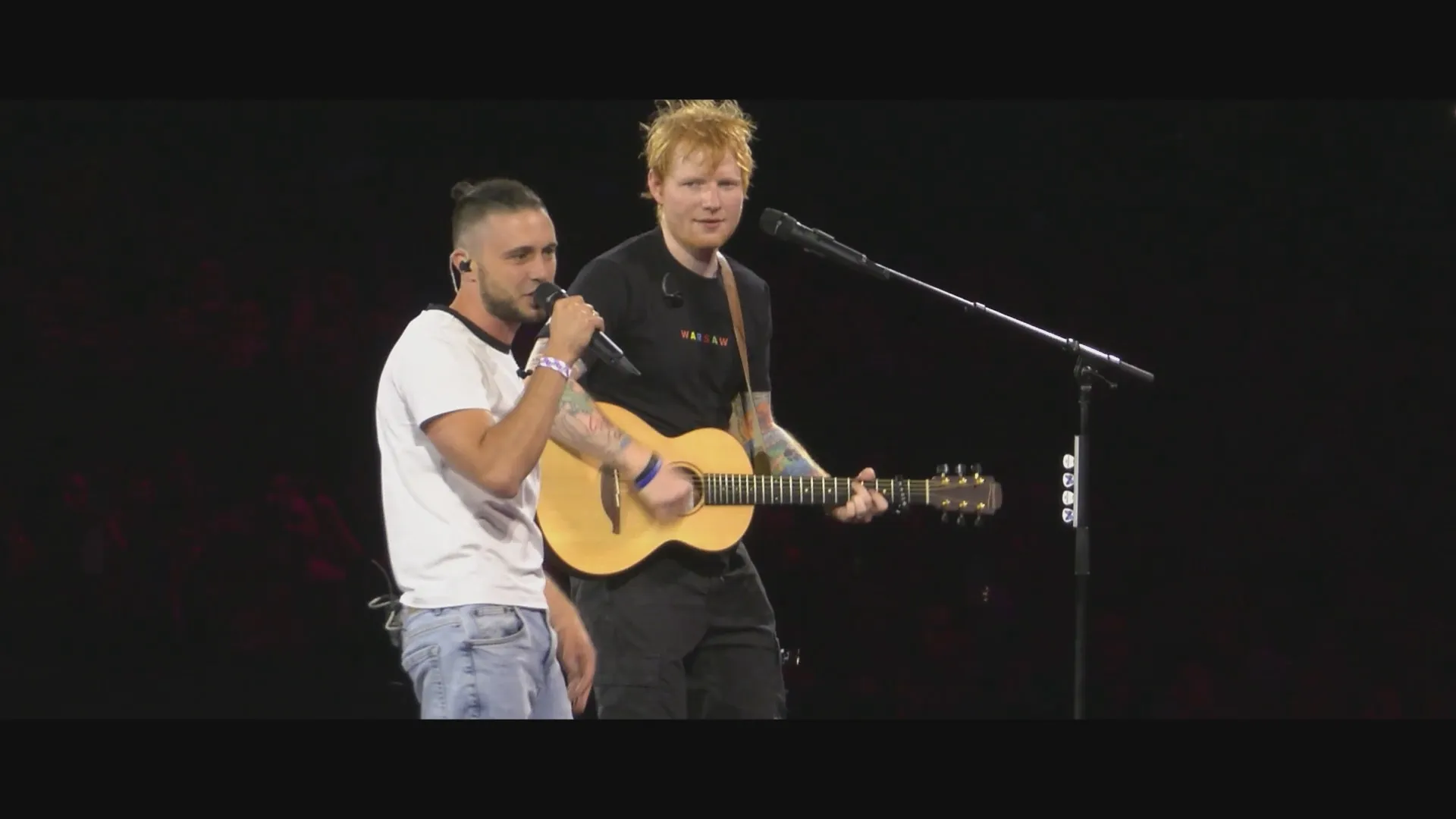 Taras Topolia performs on stage with Ed Sheeran in Warsaw